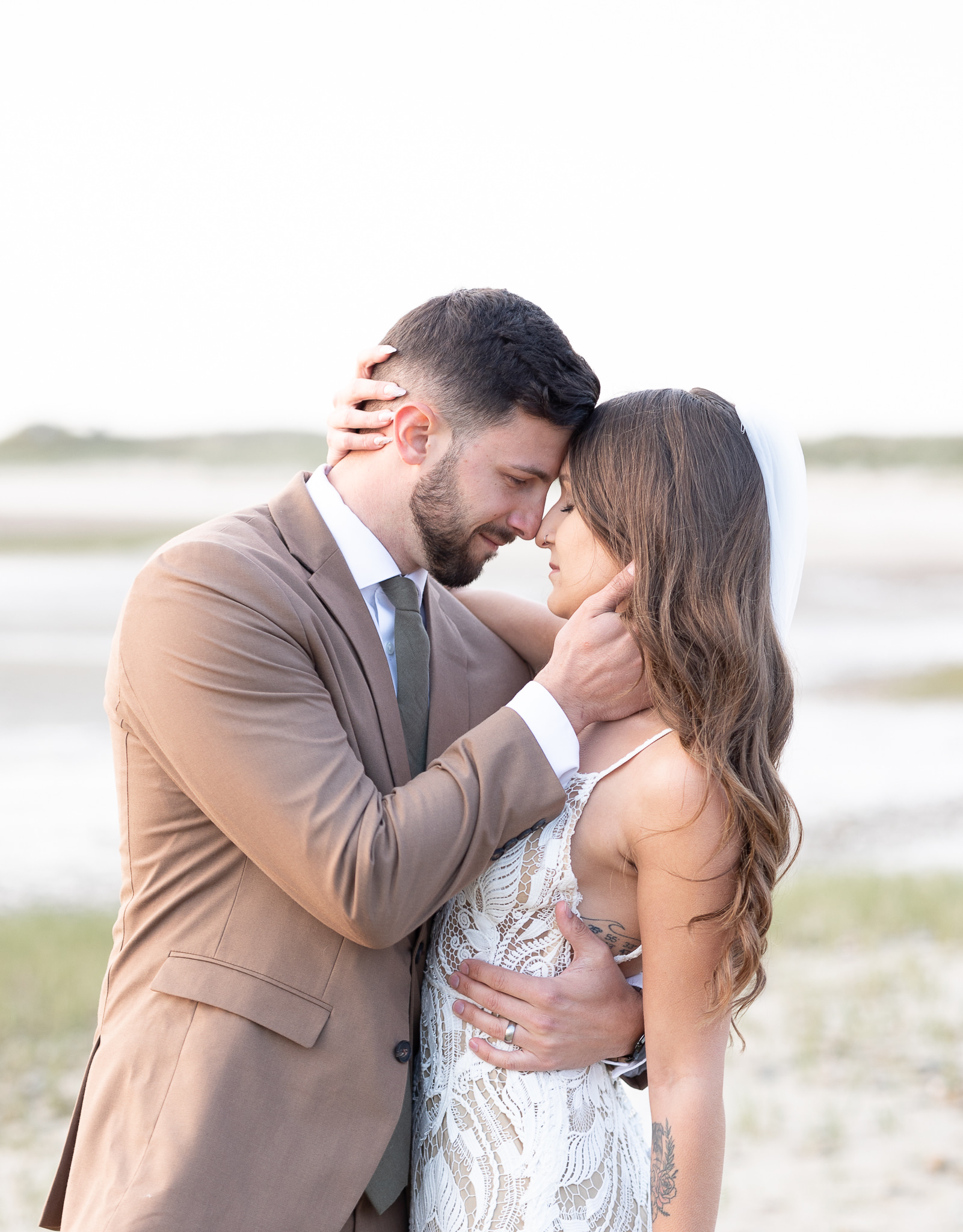 Couple eloping in Cape Cod on a beach at sunset