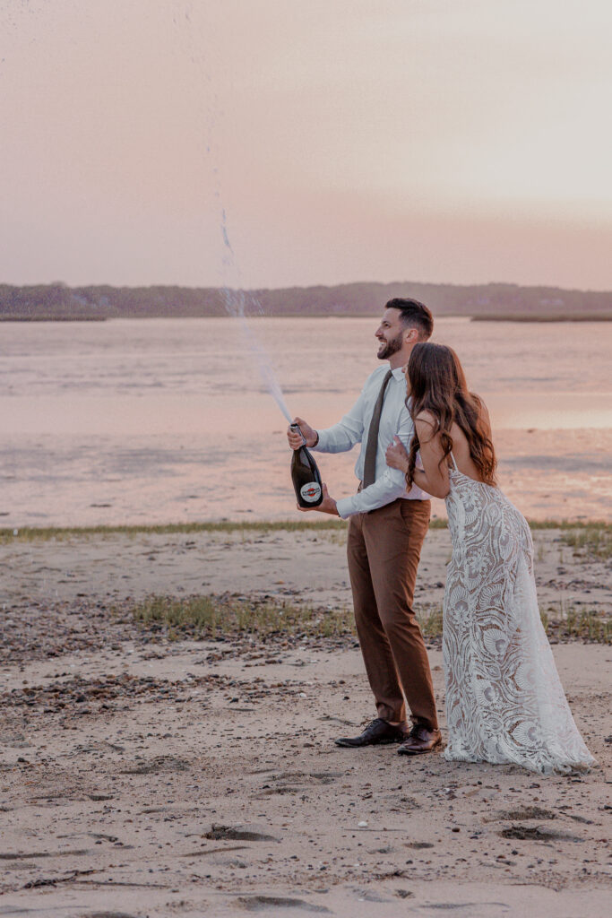 fun champagne pop at the end of a romantic Cape Cod beach elopement day