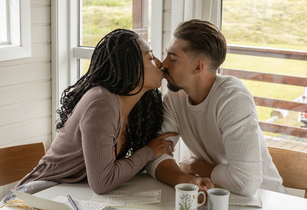 cozy couple at their airbnb drinking tea and writing their vows