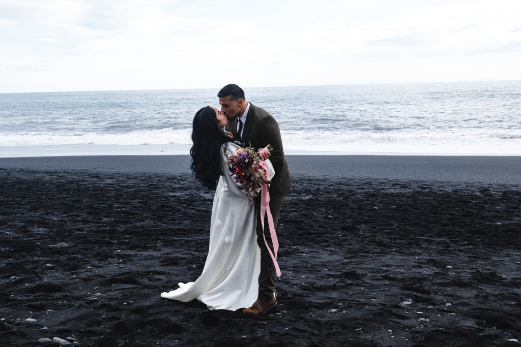 elopement couple at the black sand beach in iceland