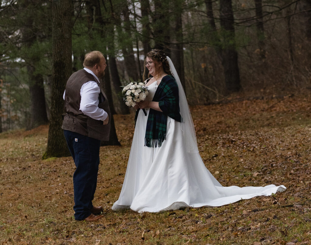 bride and groom surrounded by fall foliage during their new england elopement