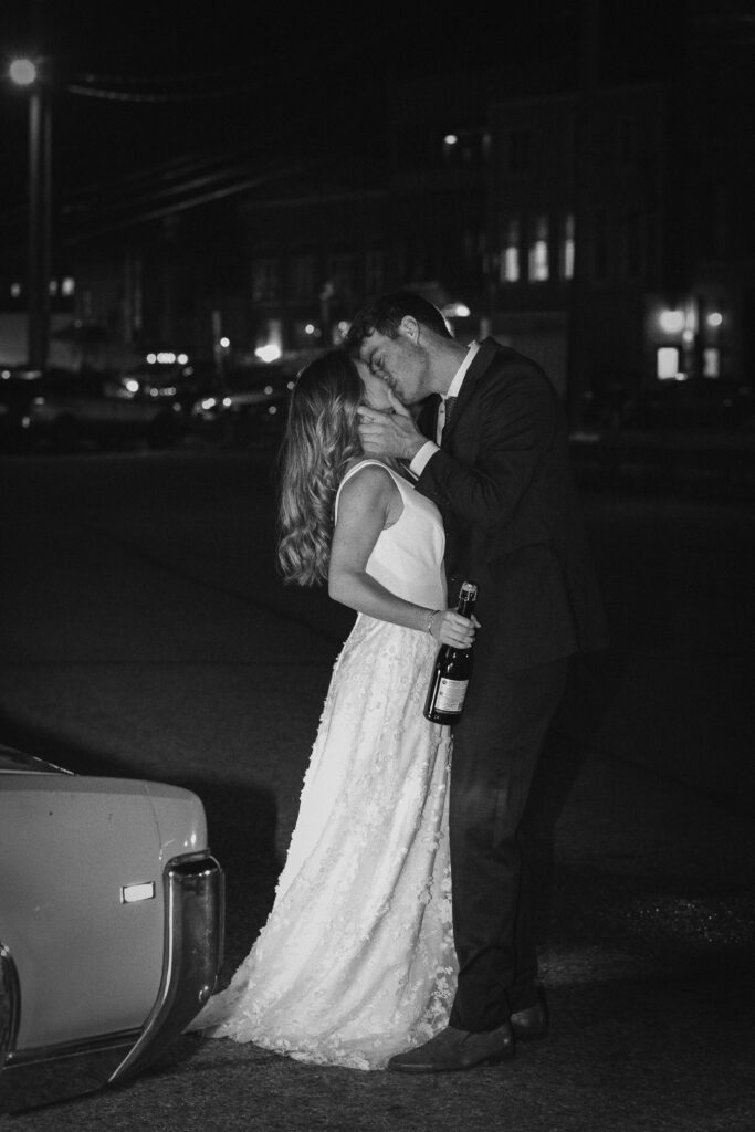 moody bride and groom kissing in the street