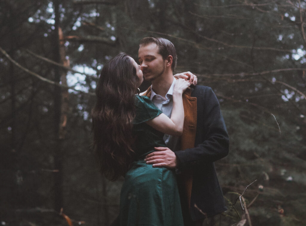 moody new england couple in the forest