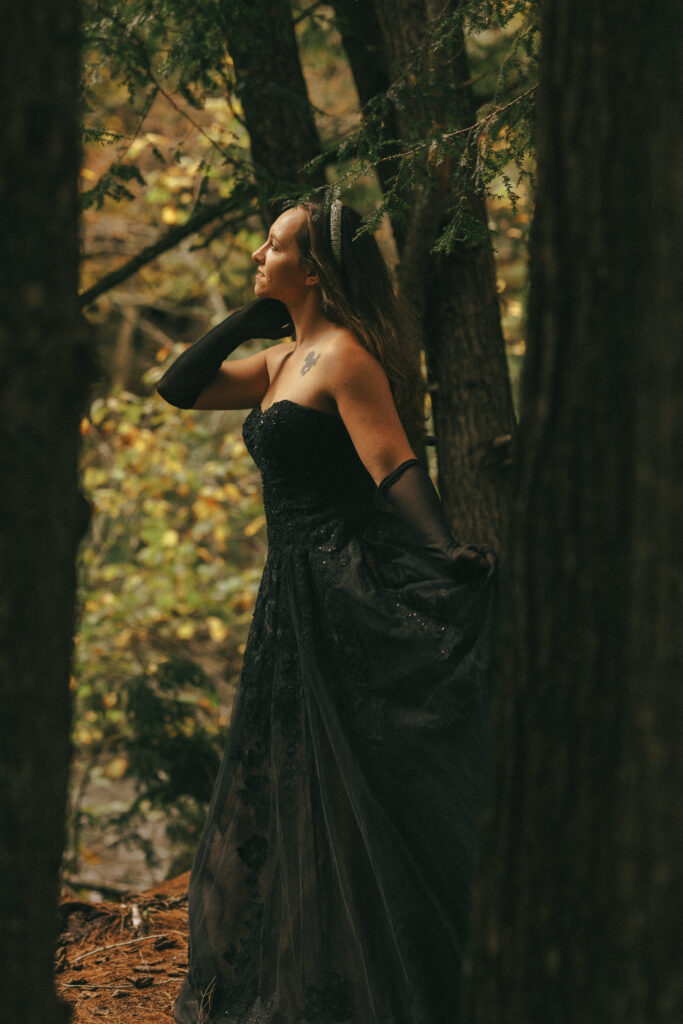 moody forest bridal portraits, bride is wearing a black wedding dress