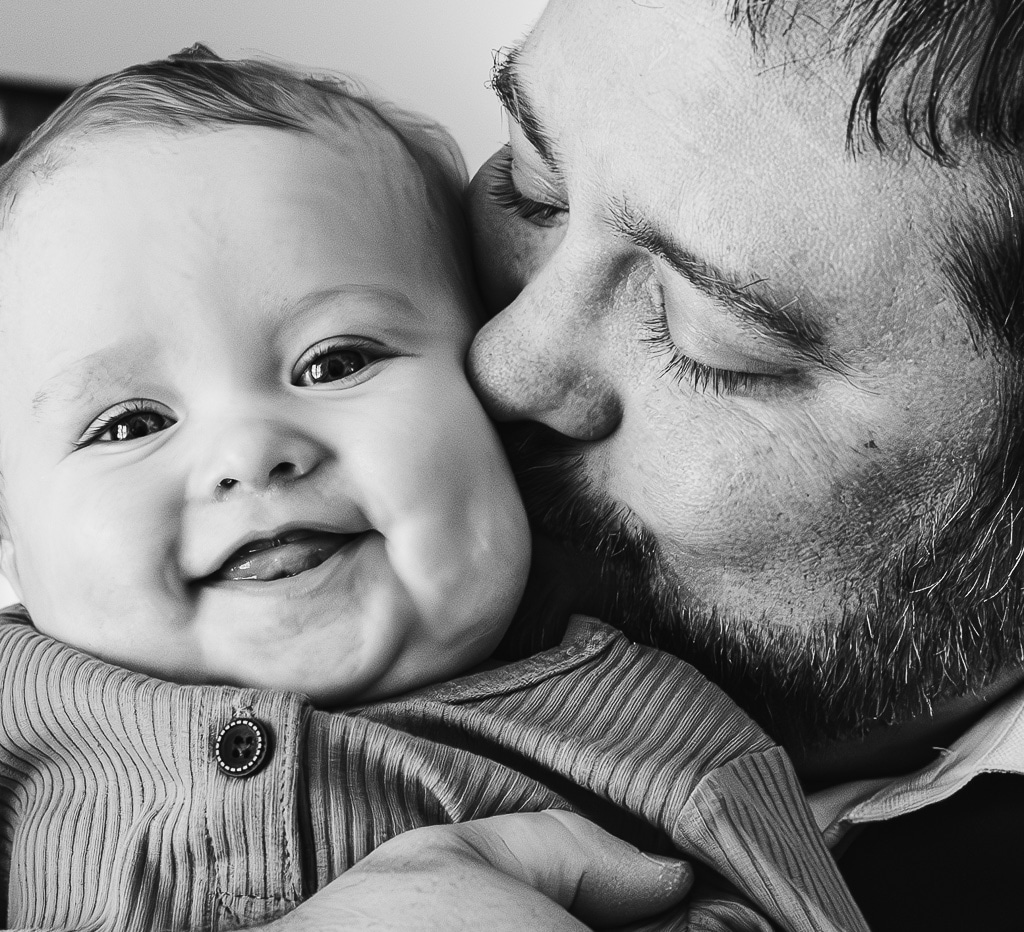 groom kissing his son on the cheek