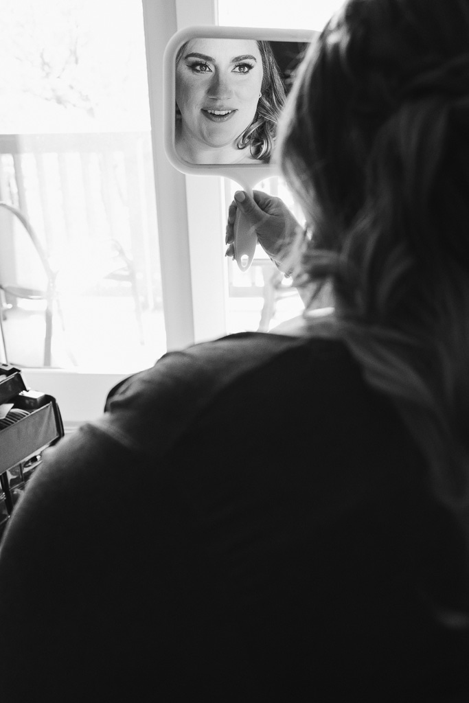 bride getting ready for the stowe, vermont elopement at spruce peak lodge