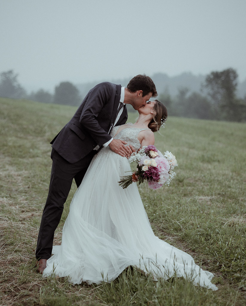 bride and groom in a field with  mountain backdrops during their berkshires elopement