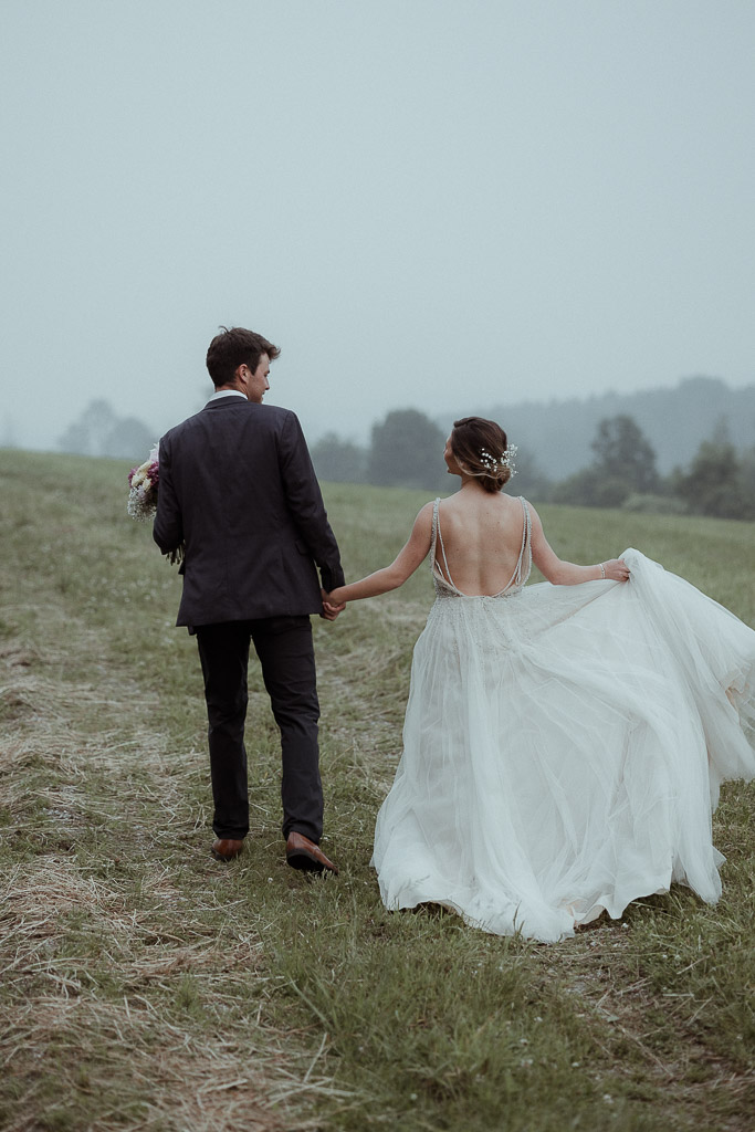 bride and groom in a field with  mountain backdrops during their berkshires elopement