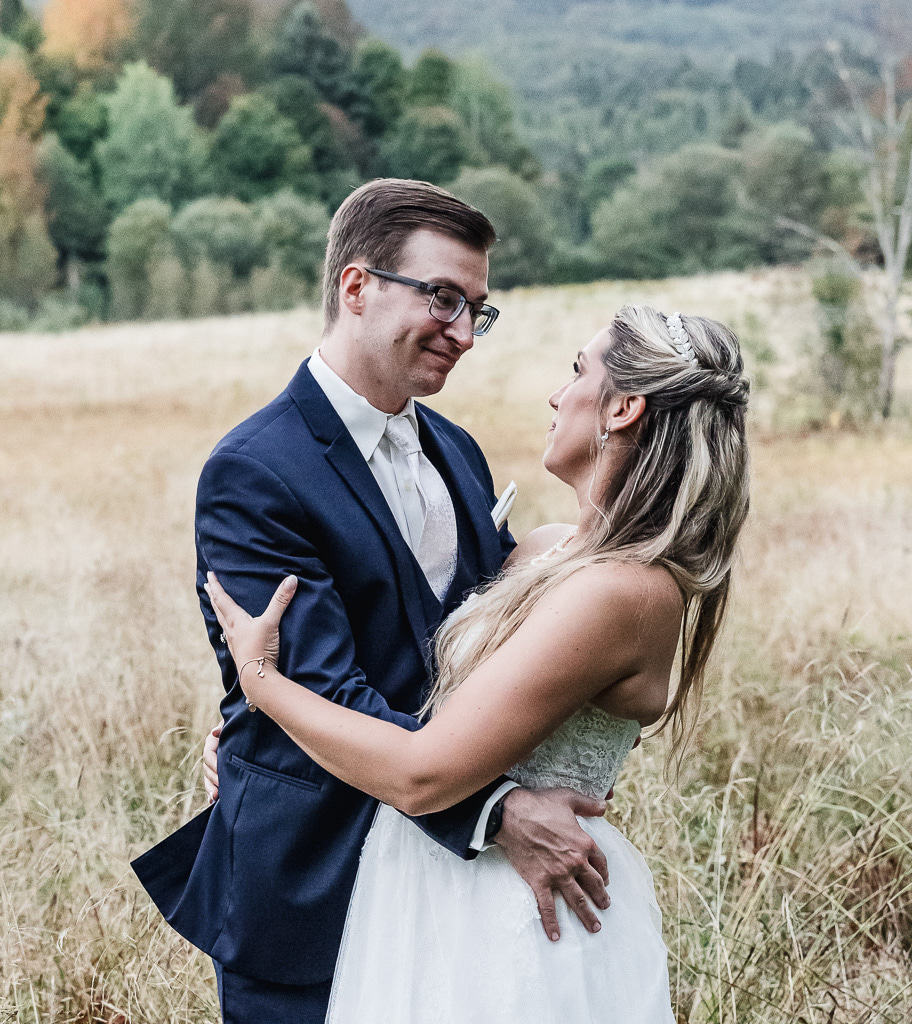 bride and groom in a field with  mountain backdrops during their berkshires elopement