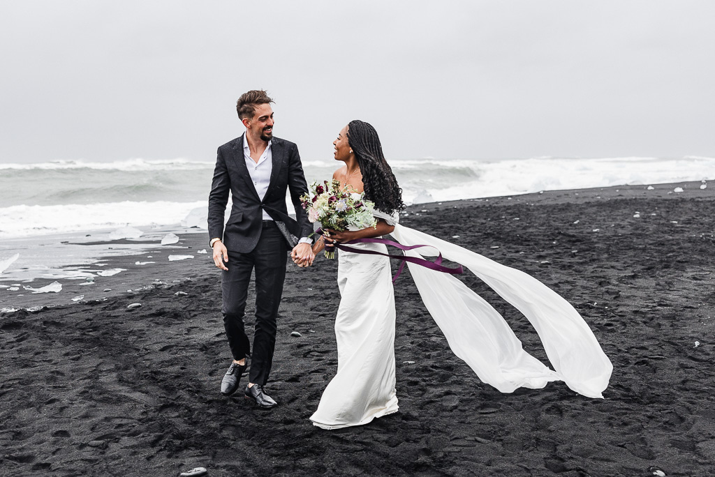 couple eloping in iceland on a black sand beach