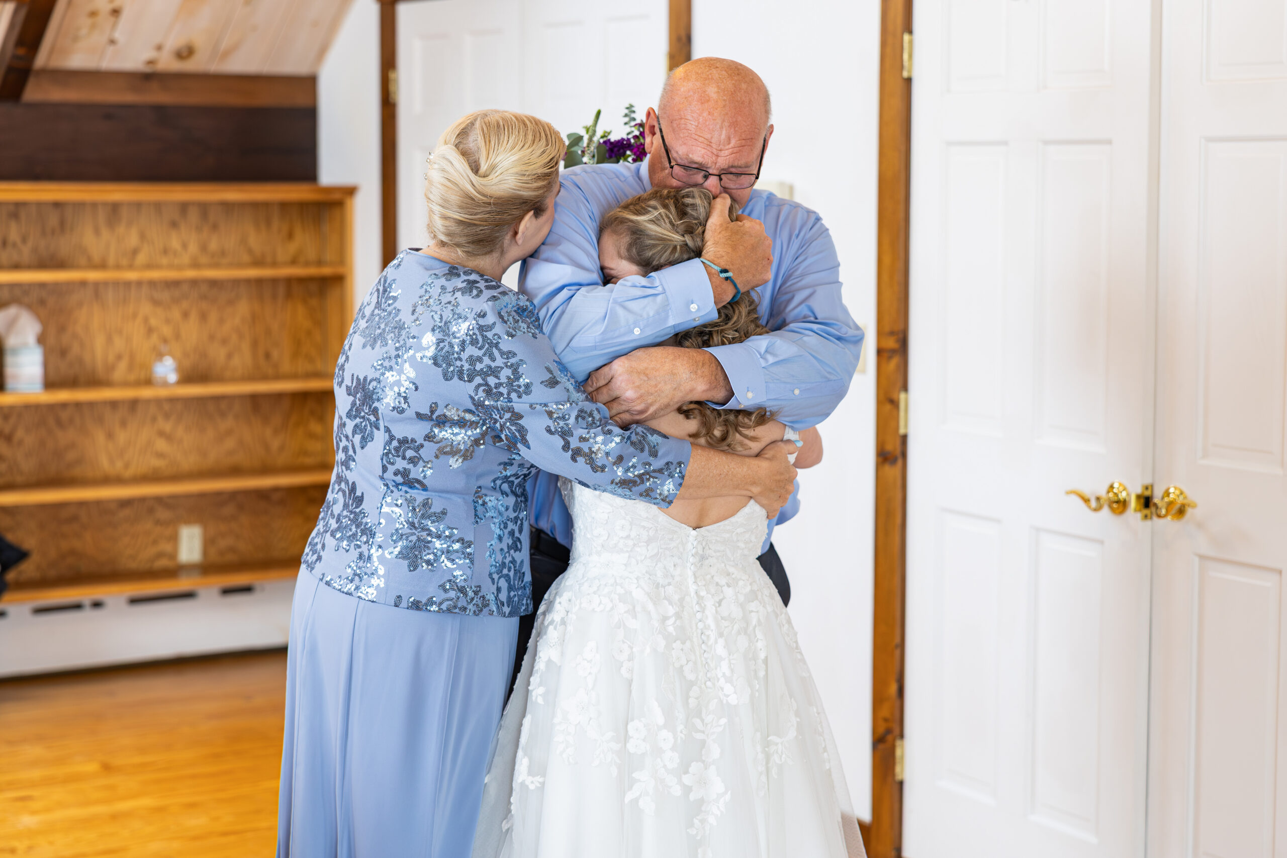 a brides first look with her parents on her wedding day